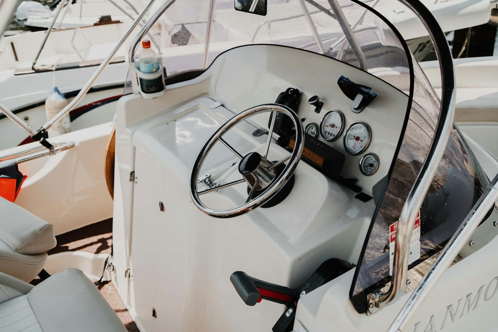 Chrome steering wheel and gauges at a center-console helm